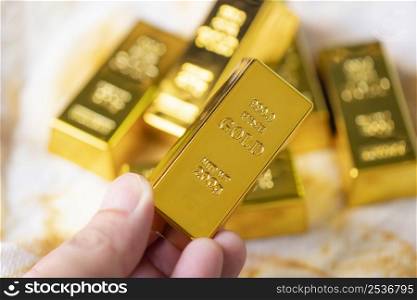 Gold bars in hand, Stack of gold bars financial business economy concepts, wealth and reserve success in business and finance