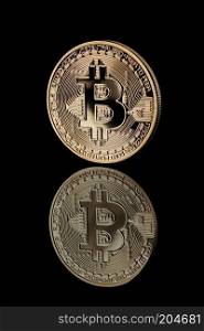 Gold Bitcoin Coin. Reflection of bitcoin icons on a black background. Bitcoin cryptocurrency. Business concept.. Gold Bitcoin Coin on black background.