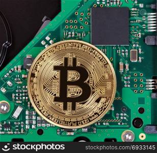 Gold Bitcoin on computer circuit board