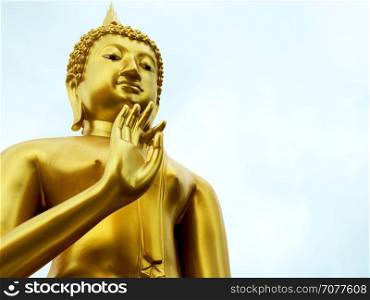 Gold Buddha statue in blessing with copy space.