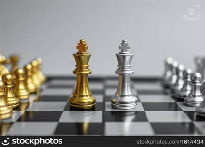 Gold Chess King figure and Checkmate enermy or opponent during chessboard competition. Strategy, Success, management, business planning, tactic, politic and leadership concept