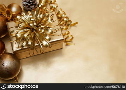 Gold Christmas background with gift and baubles