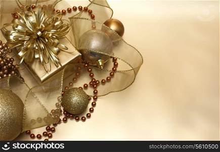 Gold Christmas background with ribbon, baubles and gift