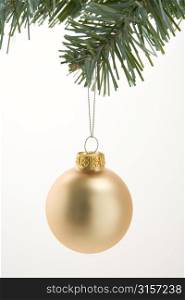 Gold Christmas Decoration Hanging From Tree Against White Background