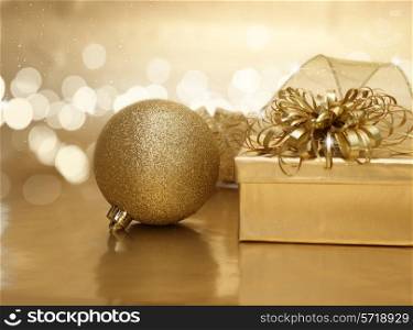 Gold Christmas decorations and gift on a bokeh lights background