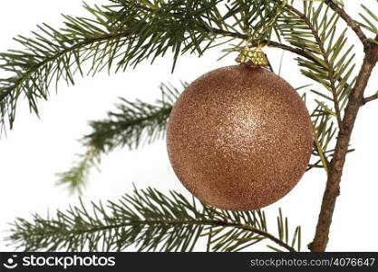Gold Christmas ornament hanging on a tree