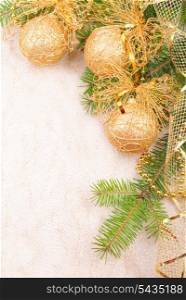 Gold Christmas ribbon, balls and beads on green pine branch