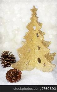 Gold christmas tree and cones on gold background
