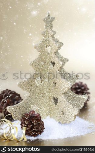 Gold christmas tree and cones on gold background