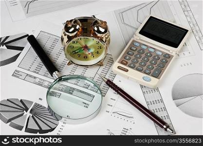gold clock and office supplies on the table