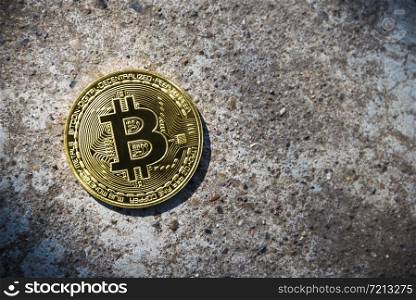 Gold coin Bitcoin on the stone background.. Gold coin Bitcoin on the stone background