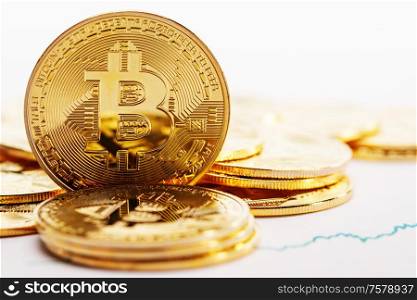 Gold coins with bitcoin sign and rate graph isolated on white background. Coins with bitcoin sign and graph