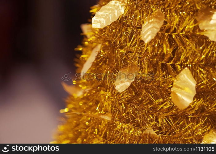 gold Decoration of artificial chrismas tree and New year festival background