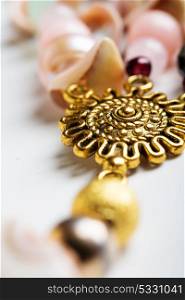 gold detail of bijouterie with semiprecious at white background