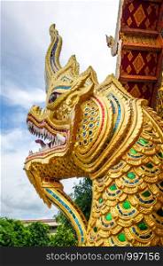 Gold dragon statue in Wat Phra Singh temple, Chiang Mai, Thailand. Dragon statue in Wat Phra Singh temple, Chiang Mai, Thailand