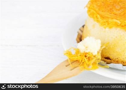 Gold egg yolks thread cake on white wood background&#xA;