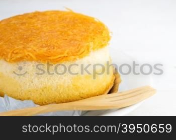 Gold egg yolks thread cake on white wood background&#xA;