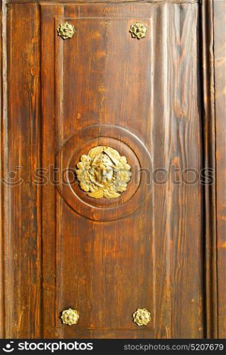 gold face abstract house door in italy lombardy column the milano old closed nail rusty