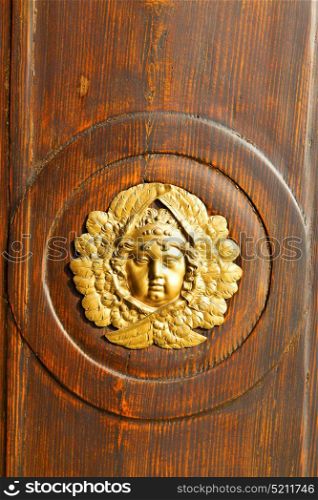 gold face abstract house door in italy lombardy column the milano old closed nail rusty