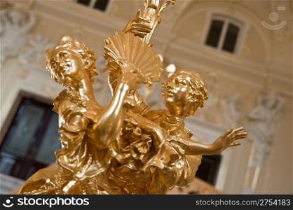 Gold figurine dancing couple. An interior of opera theatre. Odessa, Ukraine