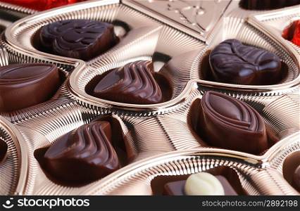 Gold foil box of assorted chocolates background