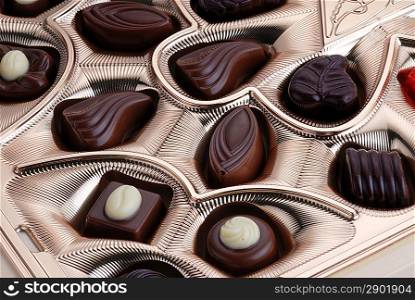 Gold foil box of assorted chocolates background