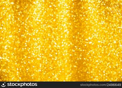 Gold glitter background of small soft shiny yellow christmas lights bokeh.