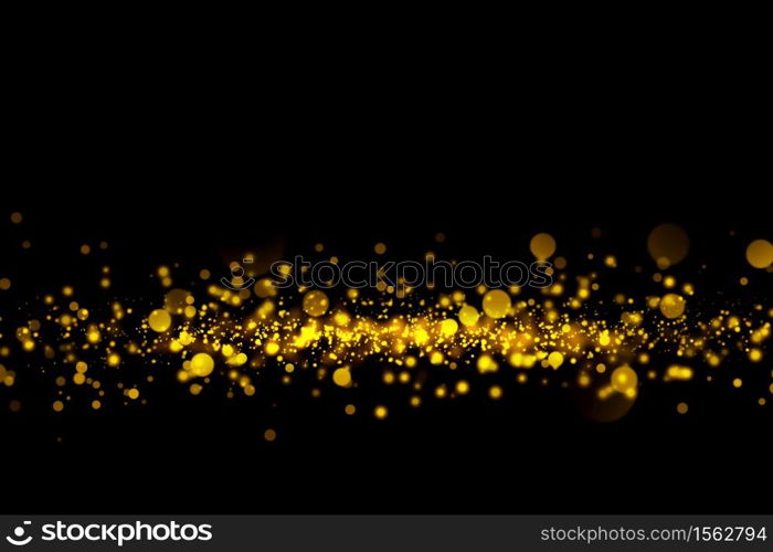Gold glitter particles lights and bokeh on a black background. Christmas abstract sparkle texture.