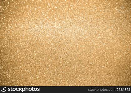 Gold glitters background. shimmering blur spot lights Bokeh Shiny gold light background texture