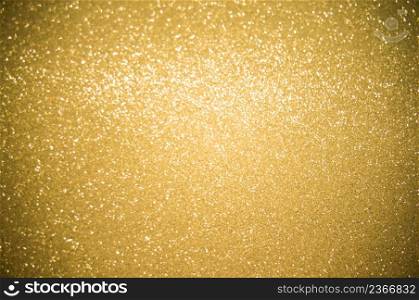 Gold glitters background. shimmering blur spot lights Bokeh Shiny gold light background texture