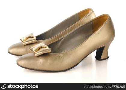 Gold high-heeled shoes isolated on white background.