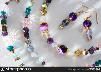 gold jewelry bracelets with semiprecious and crystal at white background