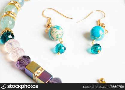 gold jewerly braslete with semiprecious and cristal at white background