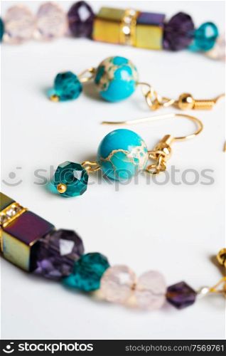 gold jewerly braslete with semiprecious and cristal at white background