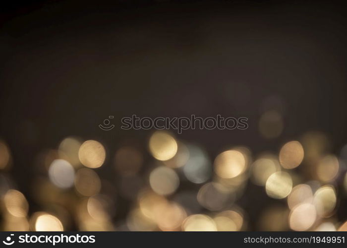 Gold light Festive Christmas background. Abstract twinkled bright background with bokeh defocused golden lights