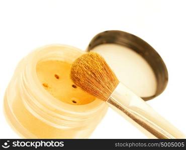 gold make-up eyeshadows and cosmetic brush