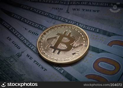 Gold metal bitcoin on top of paper dollars. BTC market symbol cryptocurrency rising above the united states dollar. Concept of shadow economy. Golden bitcoin Cryptocurrency coin on a pile of US dollars, underground economy and cryptocurrency concept