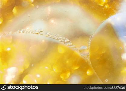 Gold Oil bubbles close up. a circles of water macro. abstract shiny light yellow background. Gold Oil bubbles close up. circles of water macro. abstract shiny yellow background