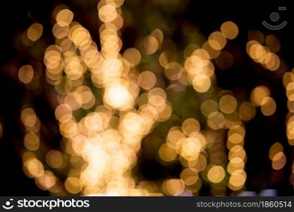 Gold or yellow bokeh texture background with glowing and illuminated, holiday and festive for celebration, New Year or Merry Christmas, no people, blur and defocused with graphic or effect.