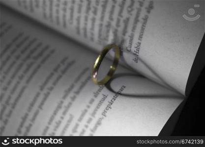 gold ring and book a romantic heart forming