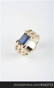 gold ring with big blue gem and smaller diamonds