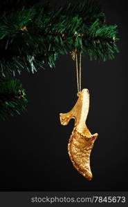 gold shoe on the artificial Christmas tree