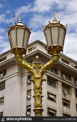 gold street lamp a palace and cloudy sky in buenos aires argentina