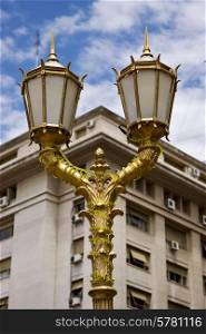 gold street lamp a palace and cloudy sky in buenos aires argentina