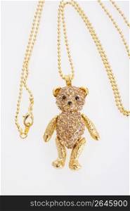 Gold teddy bear pendant on a necklace chain