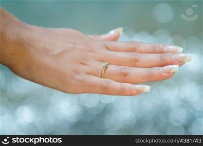 gold wedding ring on the girl&rsquo;s finger