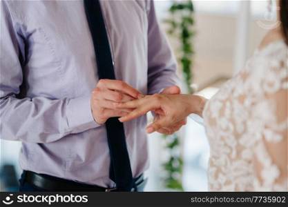 gold wedding rings as an attribute of a young couple’s wedding