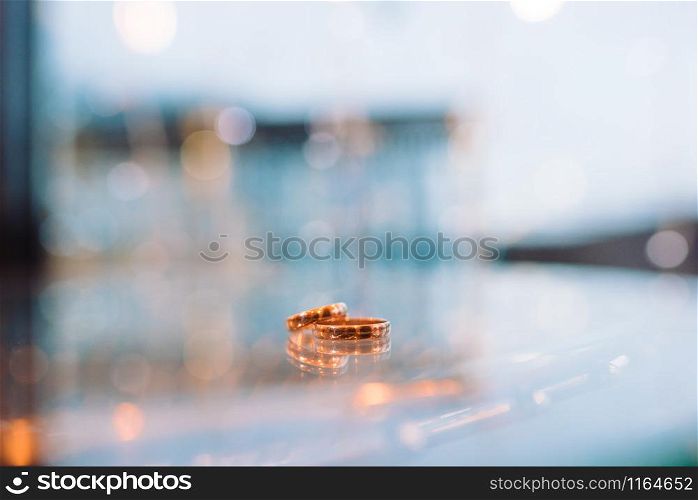 Gold wedding rings lie on a glass table. Gold wedding rings lie on a glass table close-up