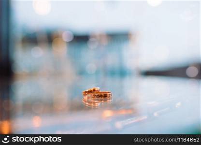 Gold wedding rings lie on a glass table. Gold wedding rings lie on a glass table close-up