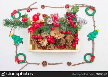 gold wood box full of Christmas decorations with fir branches and garland